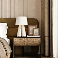Patterned Bedside Table With White Lamp Photo Frames And Books Against Textured Wallpaper In Bedroom