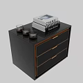 Elegant Black Chest of Drawers with Gold Trim Crocodile Texture and Decorative Books
