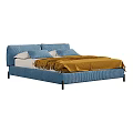 Blue Upholstered Double Bed With Tufted Headboard White Pillows And Yellow Blanket
