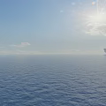 Beautiful Bright Sunny Seascape With Calm Blue Ocean Clear Sky And Distant Offshore Oil Platforms