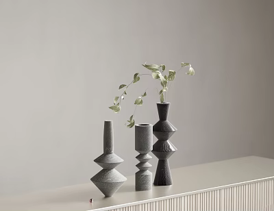 Minimalist Decorative Geometric Vases In Gray Black With Leafy Sprigs On White Countertop 3d model