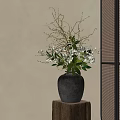 Gray Ceramic Vase With White Flowers And Green Leaves On Wooden Stand Against Beige Wall