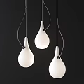 Modern White Teardrop Pendant Lights With Black Accents Hanging In Dark Background