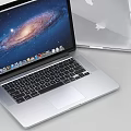 Sleek Apple Laptop Open Screen Showing Galaxy Display With Silver Body And Desktop Icons
