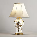 Elegant White and Gold Table Lamp with Floral Patterns and Beige Fabric Shade