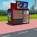 Outdoor Red Information Kiosk with Top Screen Display Surrounded by Green Grass Trees and Buildings