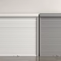 White and Gray Roller Shutters Installed Side by Side Against Wall