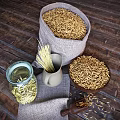 Organic Oats in Burlap Sack and Wooden Bowl with Pasta in Glass Jar on Wooden Background