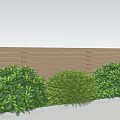 Green Leafy Shrubs Along Wooden Fence Under Blue Sky With Grass