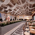 Elegant Modern Restaurant With White Wavy Ceiling Decorations Chandeliers And Flower Centerpieces On Dining Tables
