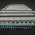 Colorful Model Train Cars in Various Colors Parked on Tracks with Windows