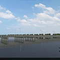 Scenic Bridge Over River With Boats Green Banks And Blue Sky