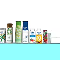 Various Beverages in Colorful Bottles and Cartons on Light Blue Background