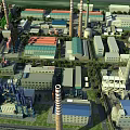 Industrial Factory Buildings With Multiple Chimneys And Colorful Rooftops In Industrial Area