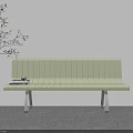Light Green Outdoor Chair with Metal Legs Next to Plant and Books on Seat