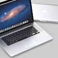 Apple MacBook Laptop With Open Galaxy Screen Display And Silver Body Design