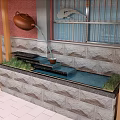Outdoor Garden Ornament Featuring Teapot Water Flow Into Stone Basin And Grass