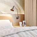 Modern Bedroom With Abstract Light Wave Texture Wall Beige Headboard White Vase Branches Photo Frames