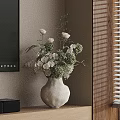 White Ceramic Vase With Fresh Green And White Flowers On Wooden Shelf