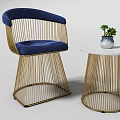 Elegant Leisure Sofa Set Featuring Blue Cushions Golden Metal Frames White Round Table And Green Plant