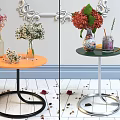 Decorative Vases With Fresh Flowers On Orange Green Round Tables With Petals