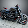 Black Cruiser Motorcycle With Red Accents On Gray Stone Pavement