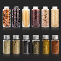 Clear Glass Spice Bottles with Silver Lids Holding Various Spices and Grains Arranged in Rows