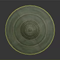 Green Circular Decorative Disc With Concentric Rings And Central Radial Pattern