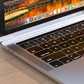 Modern Laptop With Scenic Screen On Wooden Desk With Black Headphones Books And Potted Plants