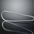 Silver U Shaped Necklace Inlaid With Small Diamonds On Black Background With Reflection