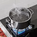 Stainless Steel Cooking Pot Boiling Water On Gas Stove With Steam And Raw Meat