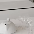 White Teapot And Clear Wine Glasses On Modern Kitchen Countertop