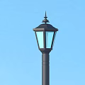 Outdoor Street Light With Black Metal Pole And Beige Stone Base Glass Shade Design
