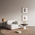 White Single Sofa With Beige Wall Two Framed Artworks Round Coffee Table Lamp And Rug