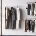 Various Clothing Items Hanging on Wall Near Window with Blinds Including Coats Sweaters and Vests