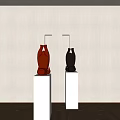 Red And Black Sculptures Displayed On White Pedestals With Wall Lamps