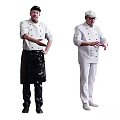 Two Professional Chefs In Black Apron And White Uniform Gesturing During Cooking Session