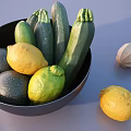 Fresh Zucchini and Lemons in Black Bowl with Wooden Juicer and Extra Lemon