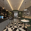 Café Interior With Rattan Chairs Black And White Geometric Floor And Pendant Lights