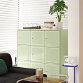 Light Green Perforated Storage Cabinet with White Blinds Plant and Black Sofa in Living Room