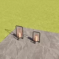 Outdoor Lantern Lights With Black Frame Illuminated On Stone Floor Among Green Plants