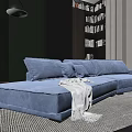 Blue Sectional Sofa with Plush Cushions and Throw Blanket in Modern Living Space