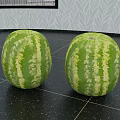 Two Fresh Green Striped Watermelons On Black Tiled Surface With Leaf Pattern Wall