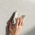 Hand Wiping Textured Gray Wall With Soft Light Colored Cloth
