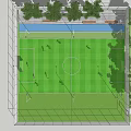 Fenced Football Field with Green Grass Surrounded by Trees and Players Playing