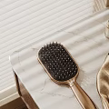 Decorative Accessories Set With Hair Brush Perfume Bottle And Silk Fabric On Marble Countertop