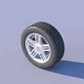 Car Tire with Silver Alloy Wheel and Tread Pattern on Light Blue Background
