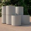 Construction Site Featuring Stacked Gray Concrete Cylinders With Green Vegetation 3d model