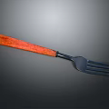 Elegant Cutlery Set With Red Wooden Handle And Black Metal Tines Design