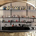 Modern Commercial Bar Equipment With Metal Mesh Shelves Bottles Coffee Machines And Geometric Counter